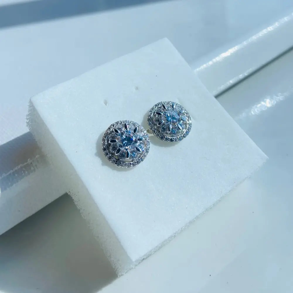 Silver ice wheel earrings with light blue gemstones and clear stones in white gold silver finish