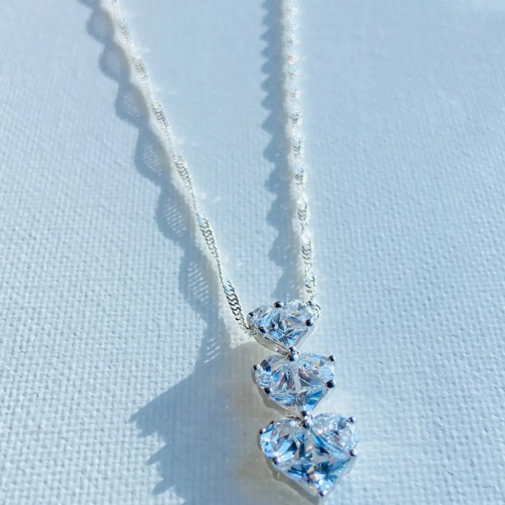 Silver three tier necklace with three heart-shaped cubic zirconia pendants in white gold silver finish. Jewellery silver jewellery Deep Shine Jewellers