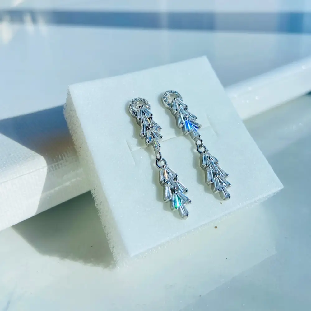 Sparkling white gold silver tapered earrings with baguette and round cubic zirconia stones