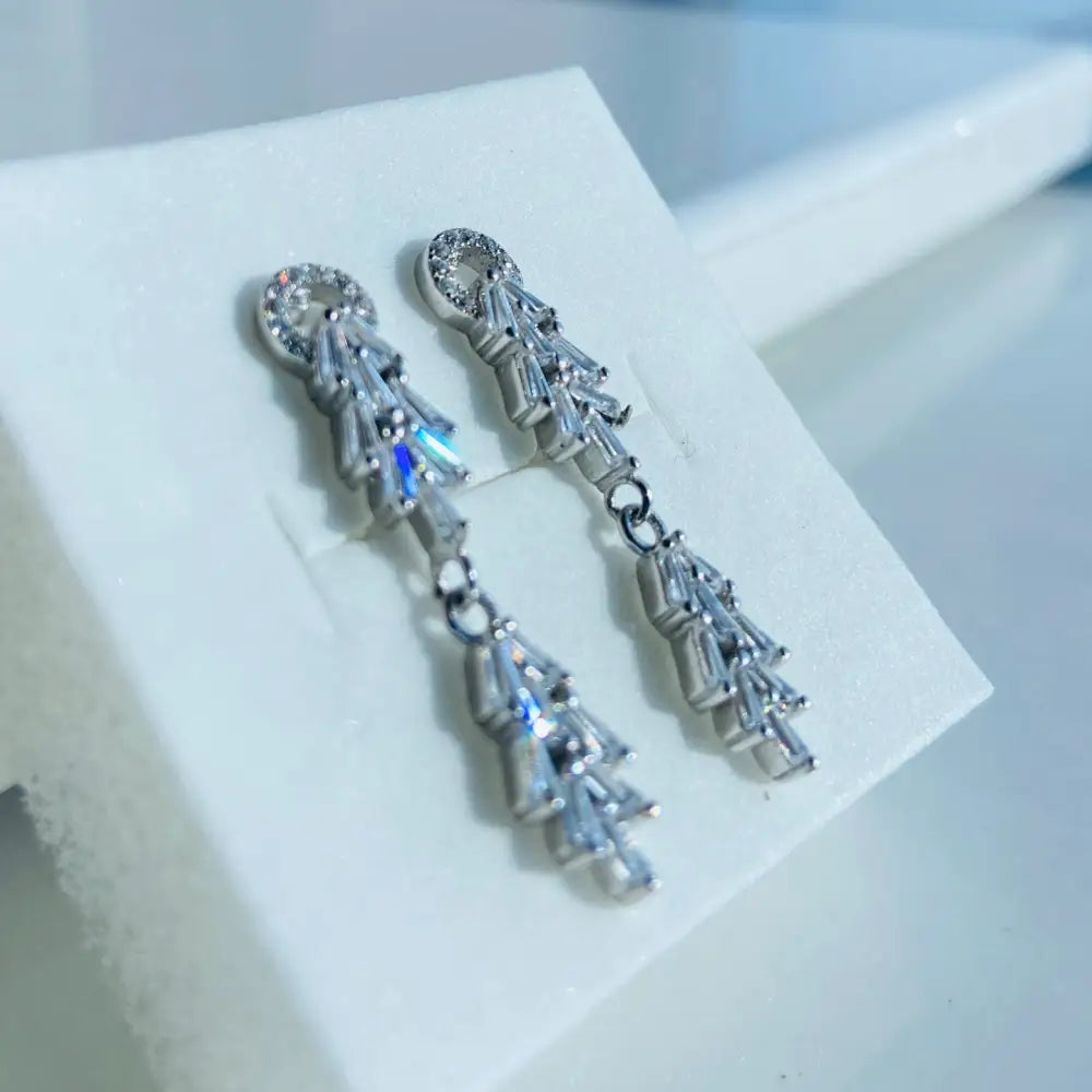Sparkling white gold silver tapered earrings with baguette and round cubic zirconia stones