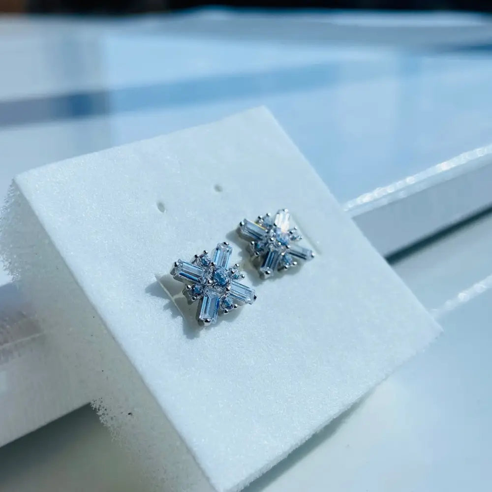 Dazzling white gold silver starburst diamond studs with baguette and round gemstones