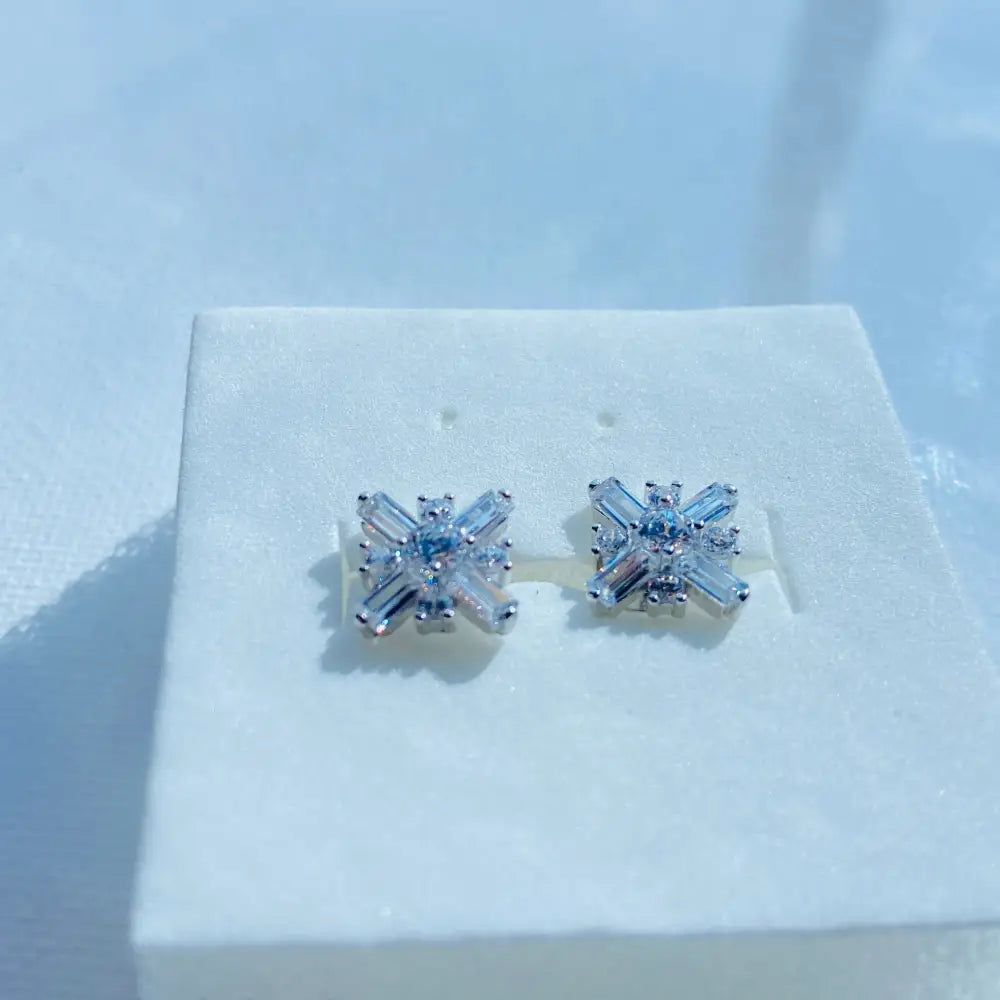 White gold silver starburst diamond studs with baguette and round gemstones