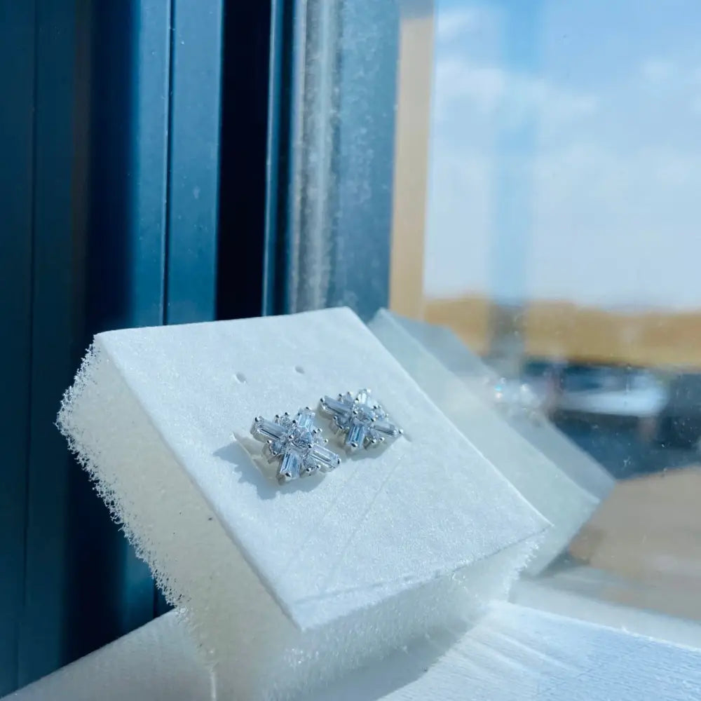 Dazzling white gold silver starburst earrings with baguette and round-cut cubic zirconia