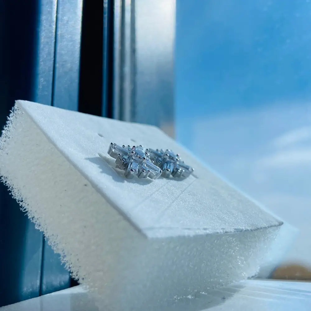 Dazzling white gold silver starburst diamond studs with baguette and round brilliant diamonds