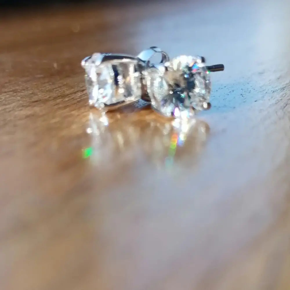 Pair of sparkling silver cubic claw earrings displayed in Deep Shine Silver Cubic Claw Earrings product