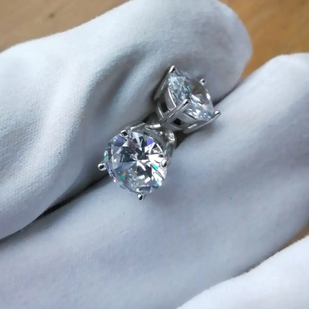 Deep Shine Silver Cubic Claw Earrings with two brilliant-cut diamond stud earrings