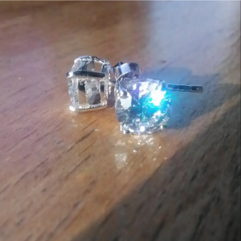 Deep Shine Silver Cubic Claw Earrings featuring two square-shaped brilliant cut gemstones