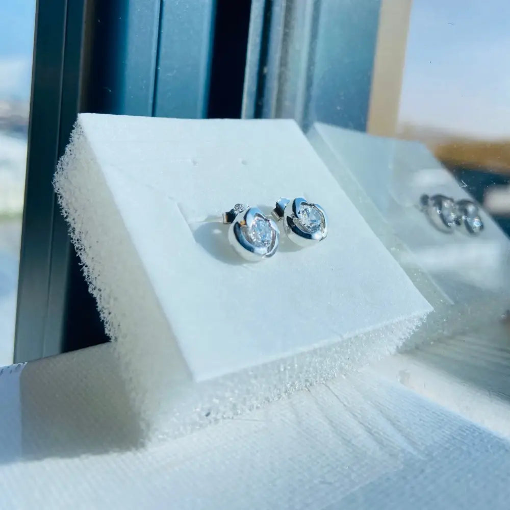 Silver rose stud earrings with clear gemstones in white gold silver bezel setting
