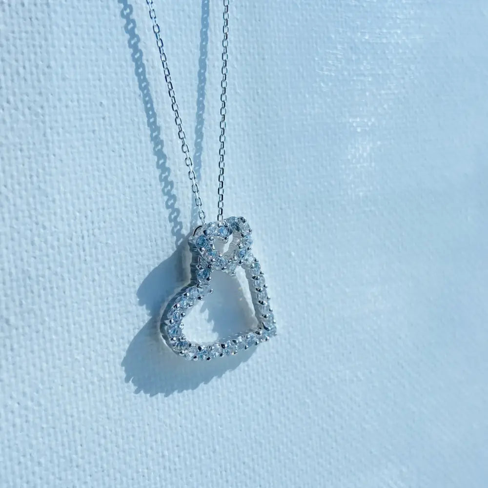 Silver double ice heart necklace with clear gemstones on a delicate chain