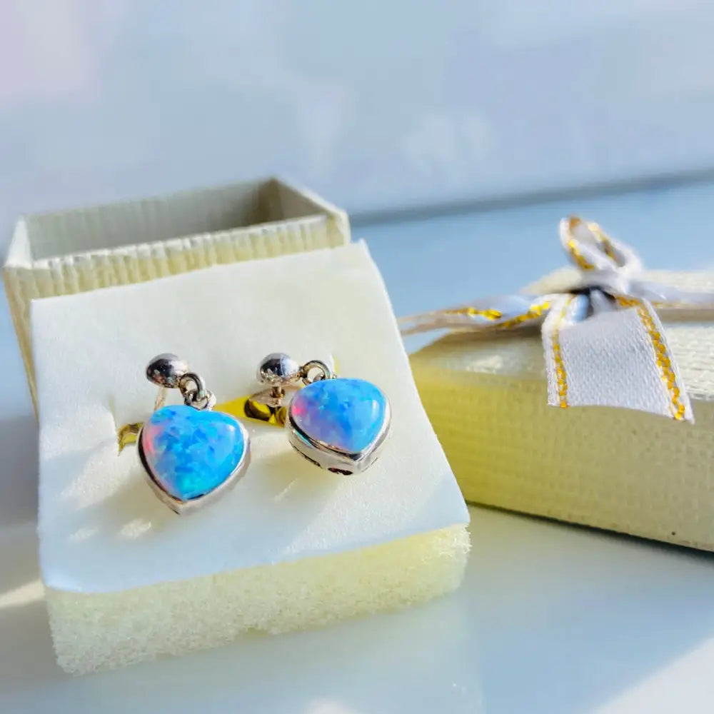 Silver earrings featuring heart-shaped opals in a stunning heart opals set design