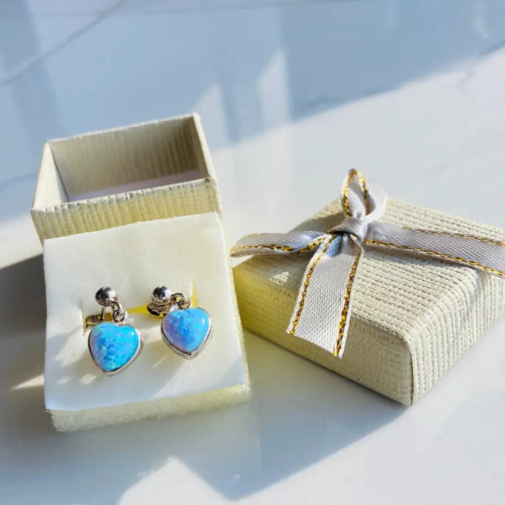 Silver earrings featuring heart-shaped opals in a stunning heart opals set design