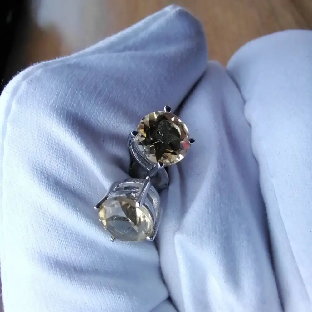Pair of white gold silver claw setting precious citrine stud earrings with round gemstones