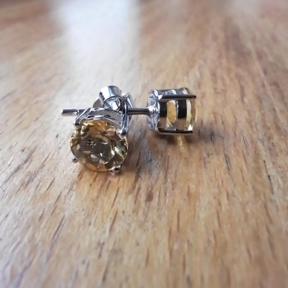 White gold silver claw precious citrine earrings with round light yellow gemstones
