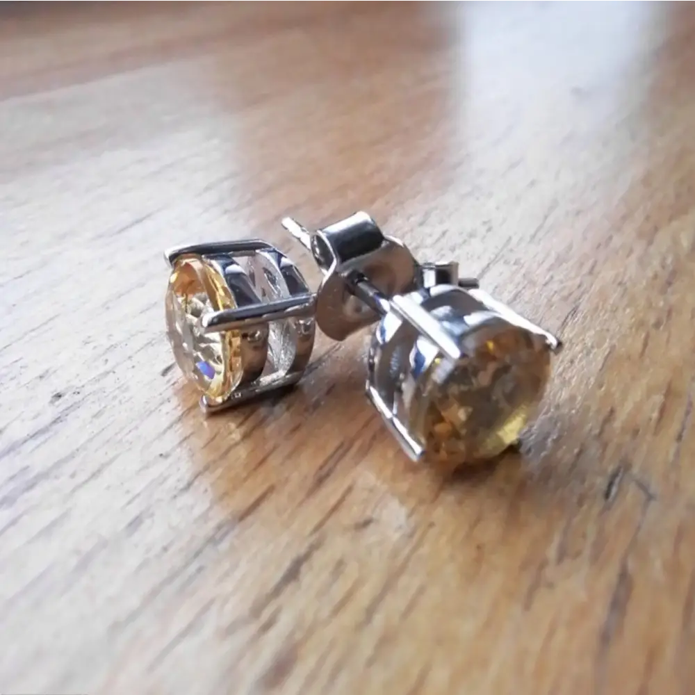 White gold silver claw precious citrine earrings with faceted yellow-orange gemstones