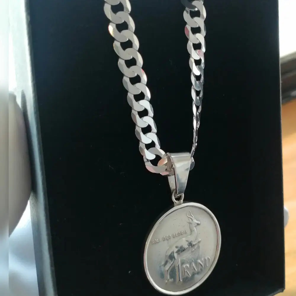 Silver flat curb necklace with a springbok coin pendant from Radiant Rand collection. jewellery silver jewellery. Deep Shine Jewellers