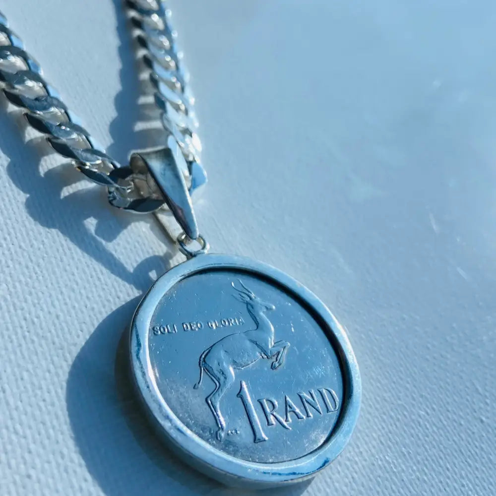 Silver flat curb necklace with South African 1 Rand coin pendant featuring a springbok design. jewellery silver jewellery. Deep Shine Jewellers