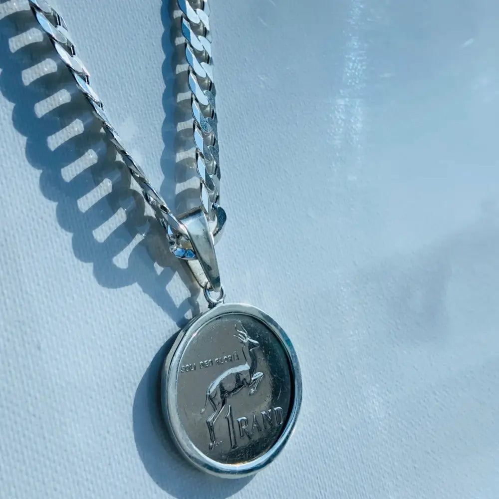 Silver flat curb necklace featuring a South African 1 Rand coin pendant with a silver flat curb chain. jewellery silver jewellery. Deep Shine Jewellers