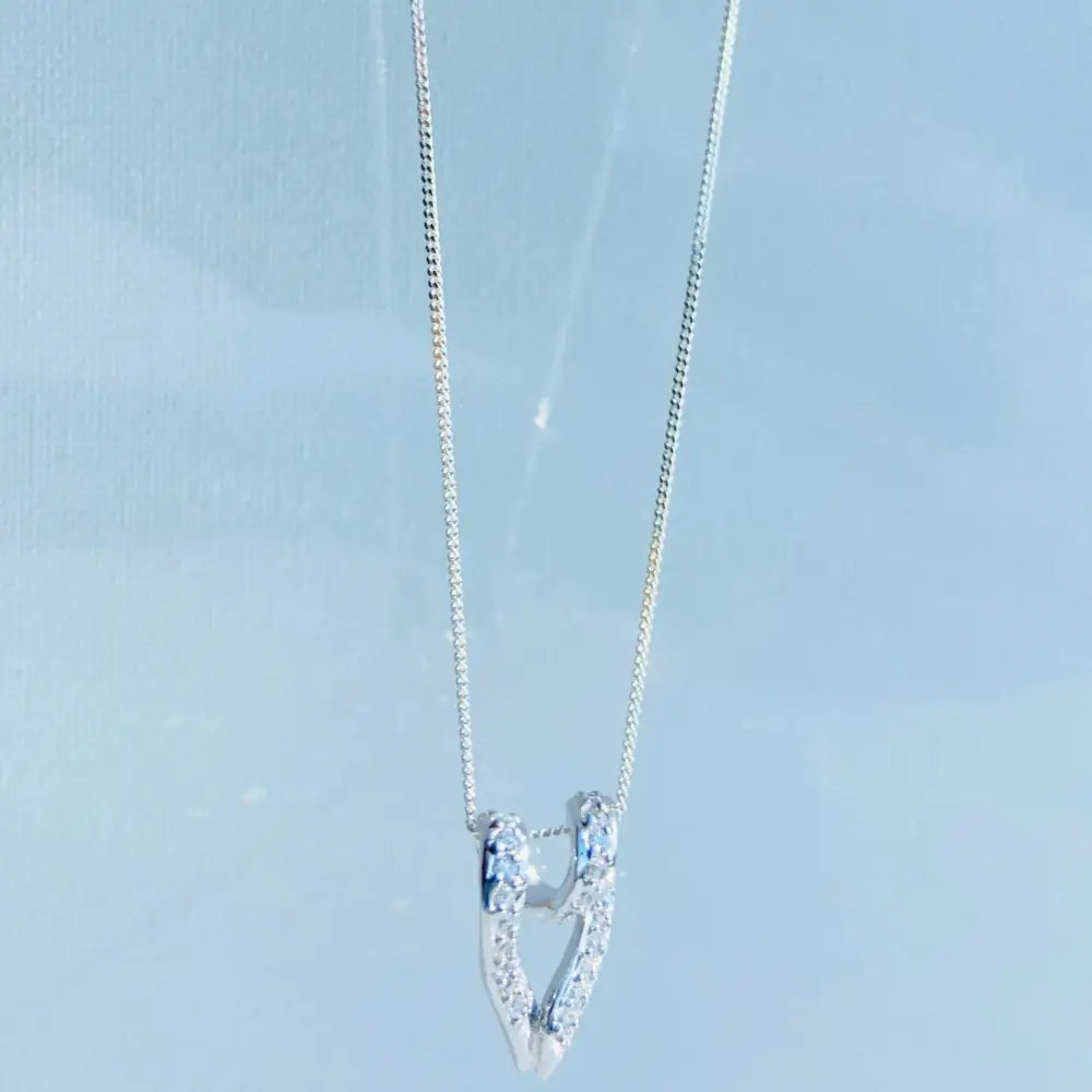 Silver looped heart necklace with diamond-encrusted U-shaped pendant for elegant jewelry style