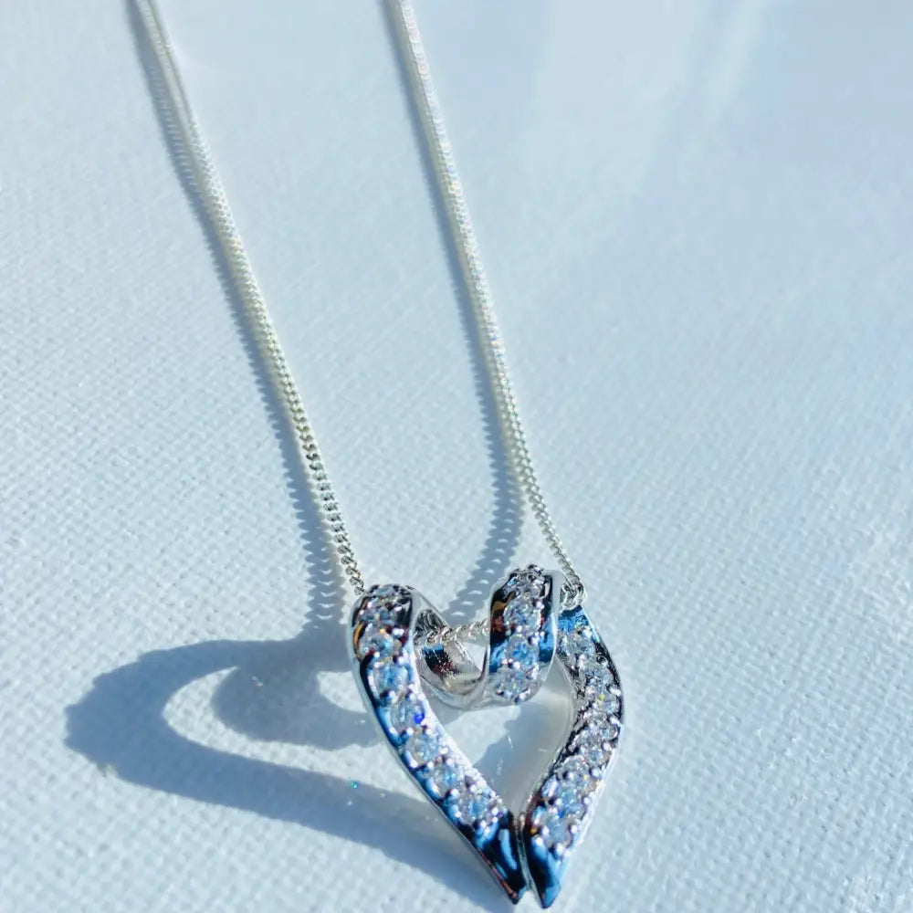 Sterling silver heart pendant necklace with pave-set cubic zirconia in Radiant Silver Looped Heart design