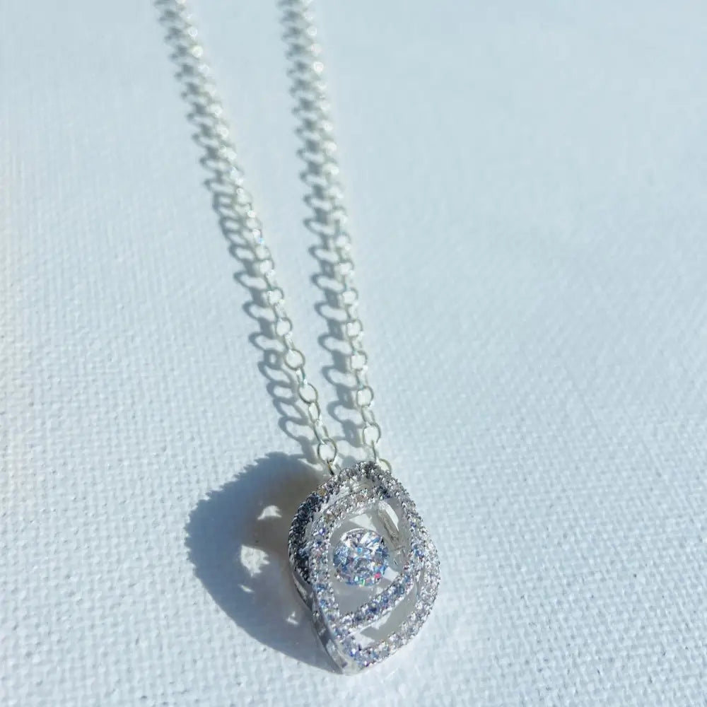 Silver chain necklace with oval-shaped eye pendant featuring clear stones and a sparkling gem. Jewellery silver jewellery Deep Shine Jewellers