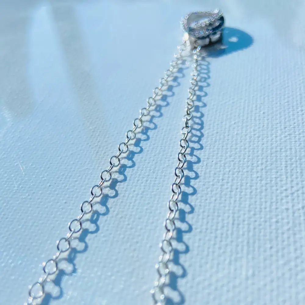 Shiny silver chain necklace with a small heart-shaped charm, part of the Radiant White Gold Dancing Eye Necklace collection. Jewellery silver jewellery Deep Shine Jewellers