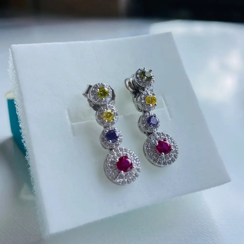 Alt text for Radiant White Gold Flooded Colourful Diamond Drop Earrings featuring bezel-set gemstones in white gold