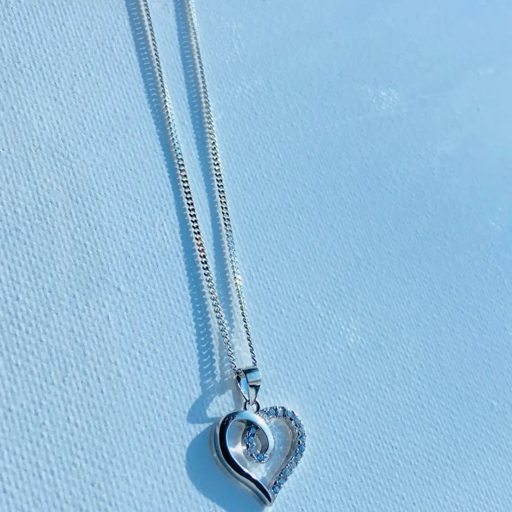White gold silver heart pendant with pave border and swirling design for Radiant White Gold Heart Necklace Sparkle. jewellery silver jewellery. Deep Shine Jewellers