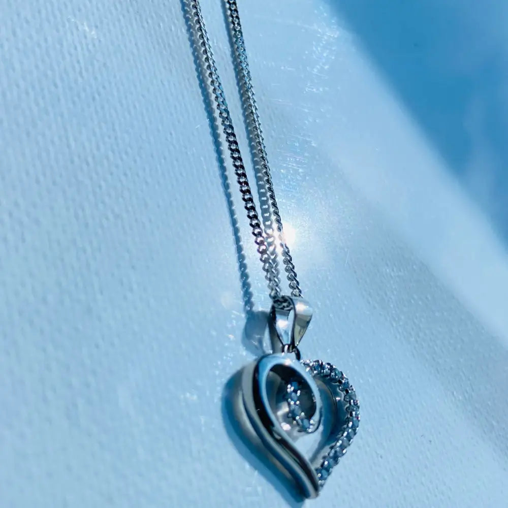 Silver heart-shaped pendant with pavé diamonds on Radiant White Gold Heart Necklace. jewellery silver jewellery. Deep Shine Jewellers