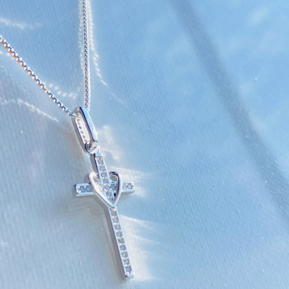 Silver-colored white gold silver love cross pendant with gemstones and heart design. jewellery silver jewellery. Deep Shine Jewellers