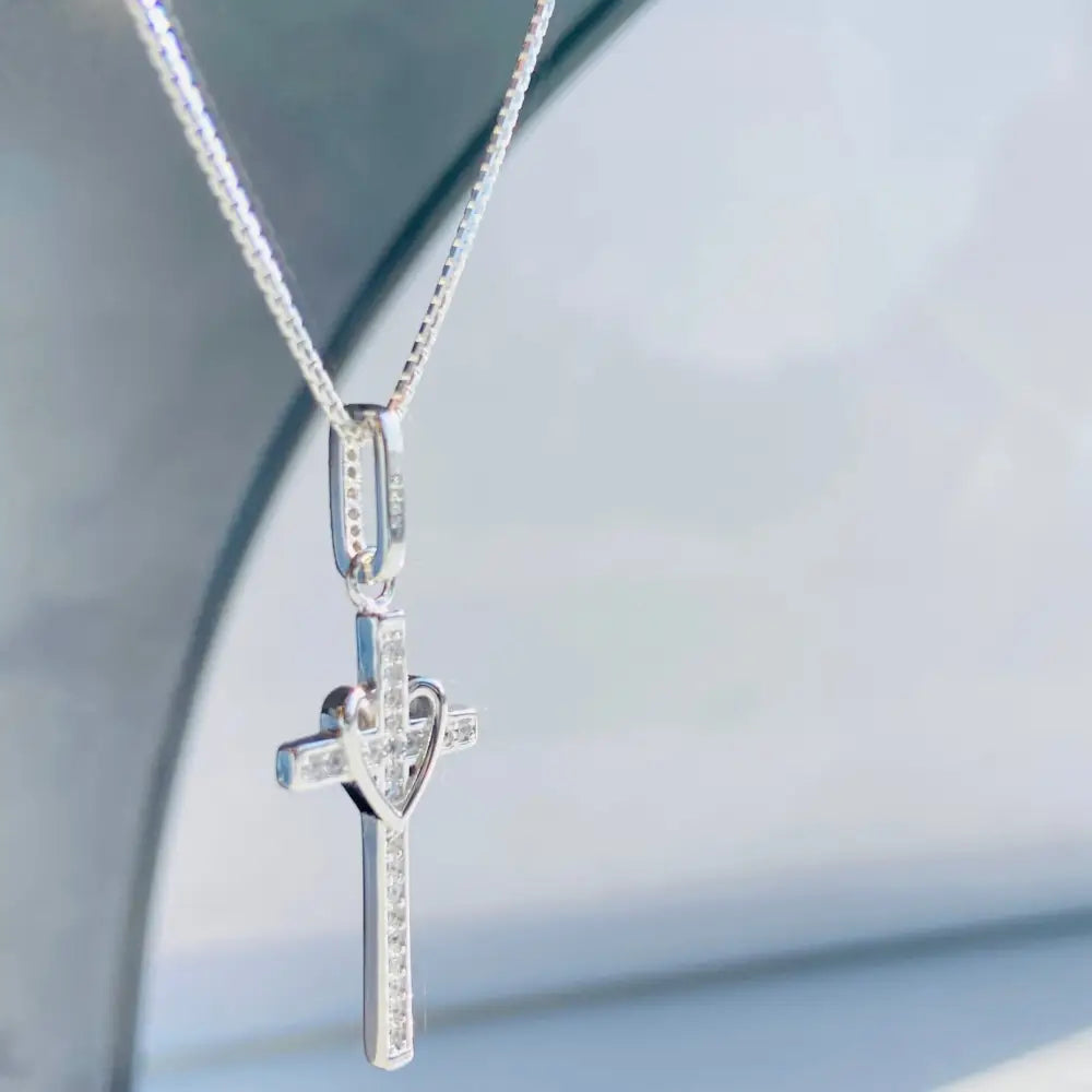 Silver-colored white gold silver love cross pendant with gemstones and heart design. jewellery silver jewellery. Deep Shine Jewellers