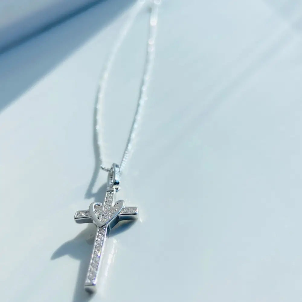 White gold silver love cross pendant with heart design and sparkling gemstones. jewellery silver jewellery. Deep Shine Jewellers
