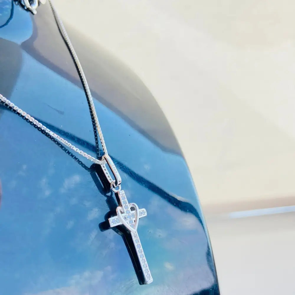 Silver-colored cross pendant with heart design and sparkling stones, in white gold silver style. jewellery silver jewellery. Deep Shine Jewellers