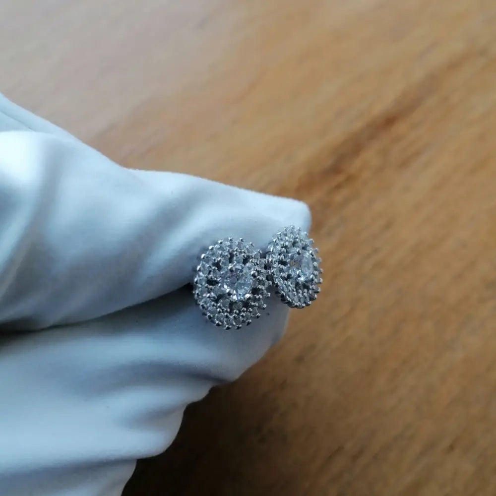 White gold silver stud earrings with clear stones in a floral sunburst design by Deep Shine Jewellers