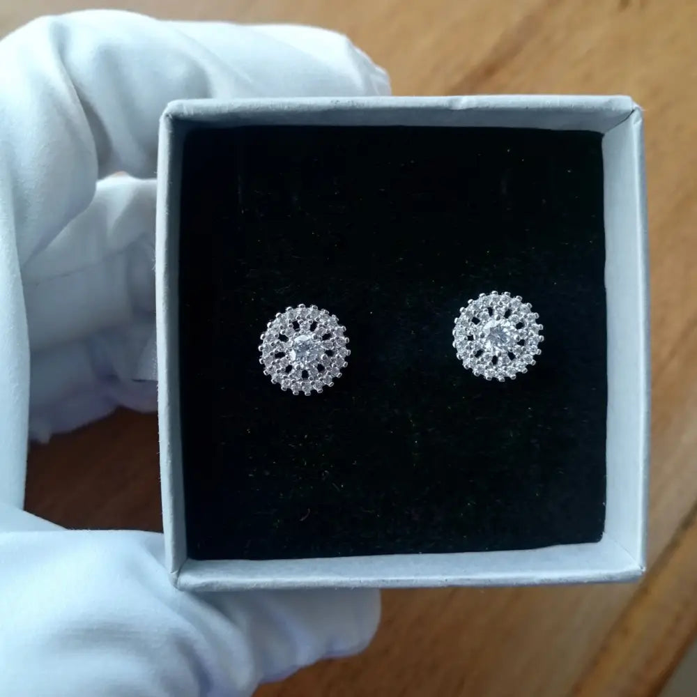 White gold silver stud earrings with clear gemstones in a floral pattern, deep shine finish