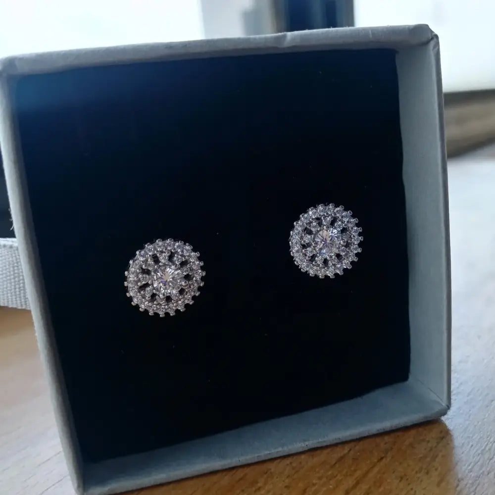 Sparkling white gold silver stud earrings with snowflake floral design and clear stones