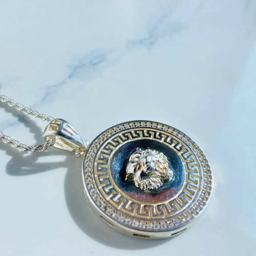 Silver and gold medallion pendant with lion head and Greek key border on a rope necklace. Jewellery silver jewellery. Deep Shine Jewellery