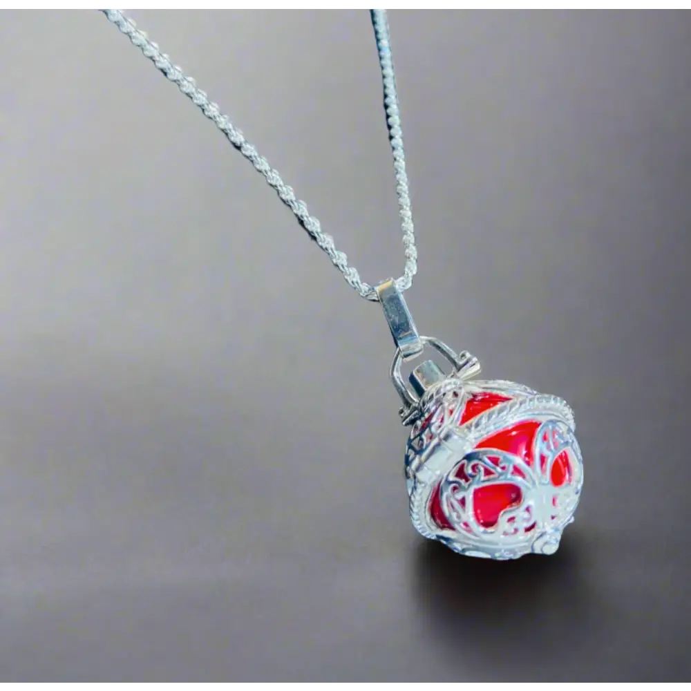 Silver locket casing featuring a silver chain necklace with an ornate spherical red pendant. Jewellery silver jewellery. Deep Shine Jewellery