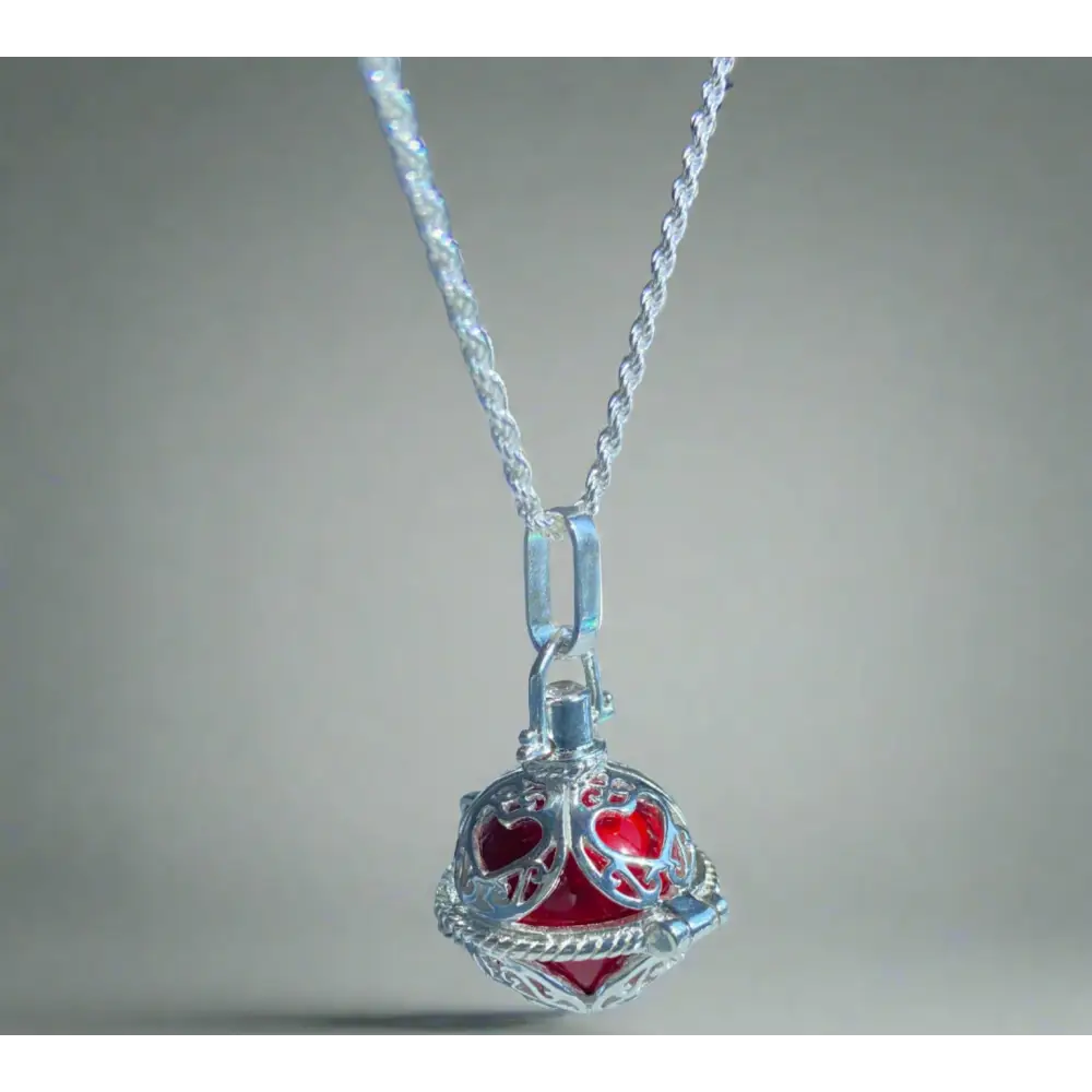 Silver locket casing featuring a red heart-patterned spherical pendant for Scarlet Heart Jewelry. Jewellery silver jewellery. Deep Shine Jewellery
