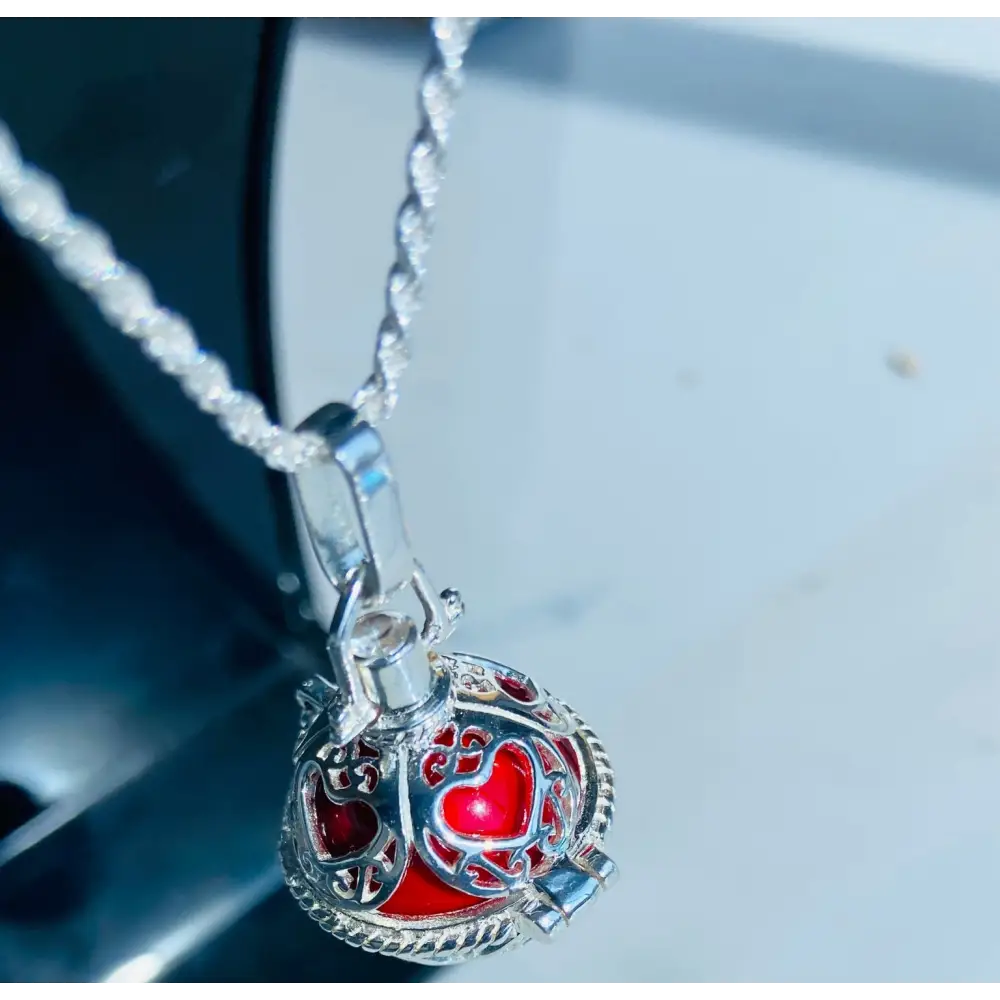 Silver locket casing featuring a heart-shaped design with a red interior for Scarlet Heart Silver Locket Adornment. Jewellery silver jewellery. Deep Shine Jewellery