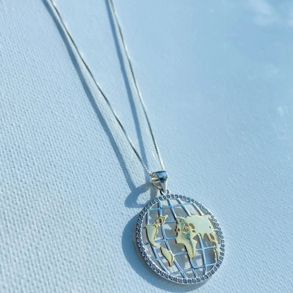 Silver world globe necklace with gold continents and diamond rim in Shimmering Silver World Globe Necklace Adornment. jewellery silver jewellery. Deep Shine Jewellers