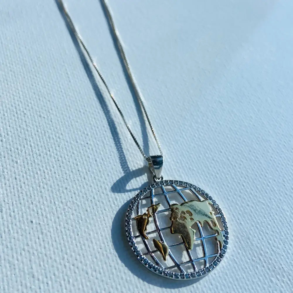 Silver world globe necklace with gold-toned map and sparkling rim for elegant style. jewellery silver jewellery. Deep Shine Jewellers