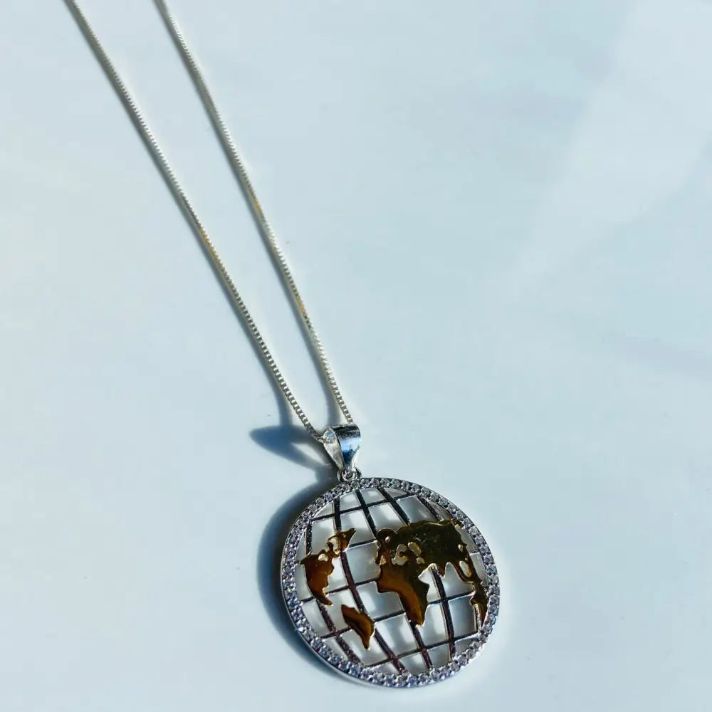 Silver world globe necklace with gold continents and diamond rim in Shimmering Silver World Globe Necklace Adornment. jewellery silver jewellery. Deep Shine Jewellers