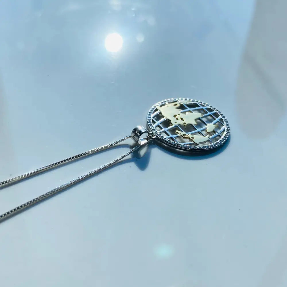 Silver world globe necklace featuring a gold-colored continents pendant for elegant style. jewellery silver jewellery. Deep Shine Jewellers