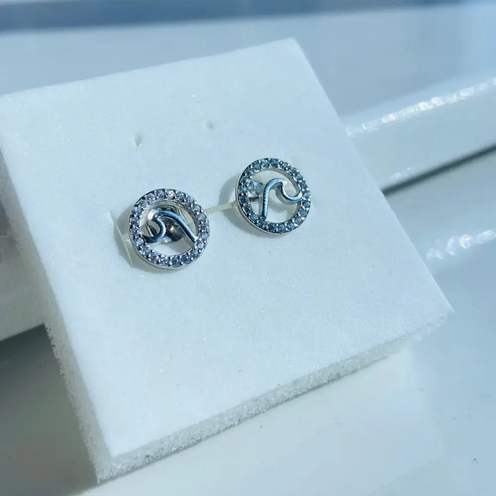 Sterling silver wave stud earrings with cubic zirconia halo in white gold silver finish