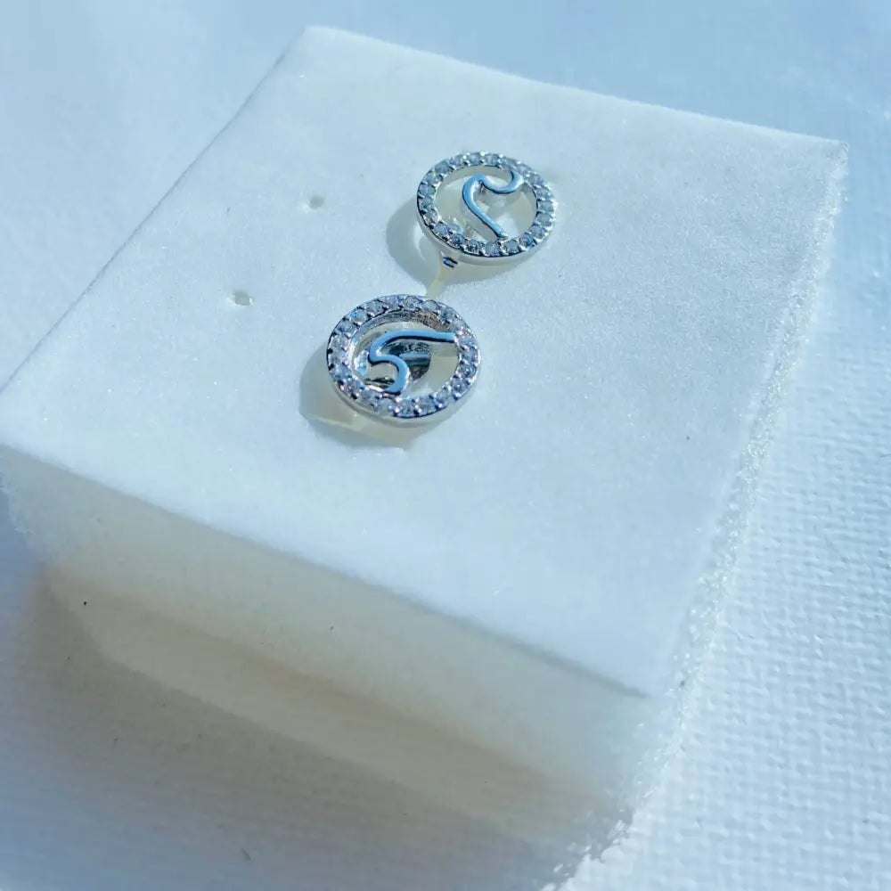 Silver Flooded Ice Wave Studs with circular design, letter S, and clear gemstone halo