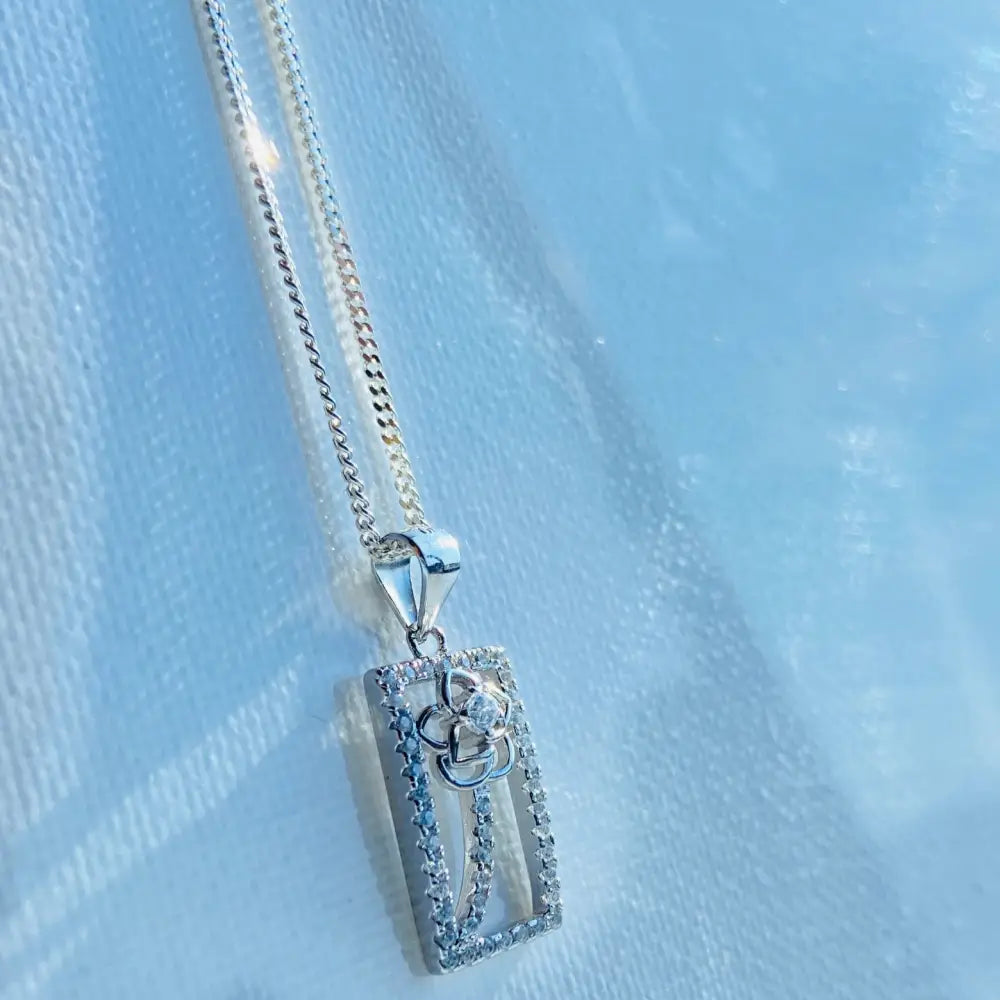 Silver chain necklace with a rectangular diamond-studded floral pendant in framed rose gold silver finish. jewellery silver jewellery. Deep Shine Jewellers