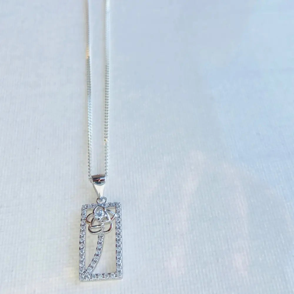 Silver chain necklace with floral design rectangular pendant in framed rose gold silver ice style. jewellery silver jewellery. Deep Shine Jewellers