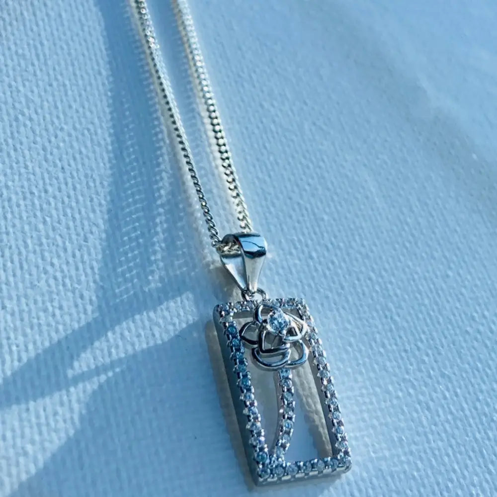 Silver chain necklace with floral design rectangular pendant in framed rose gold silver ice style. jewellery silver jewellery. Deep Shine Jewellers