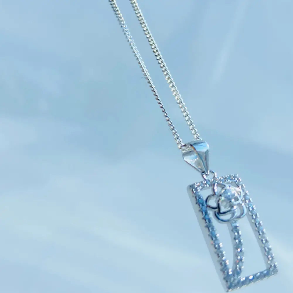 Silver chain necklace with a rectangular diamond-encrusted pendant featuring a diamond flower design. jewellery silver jewellery. Deep Shine Jewellers