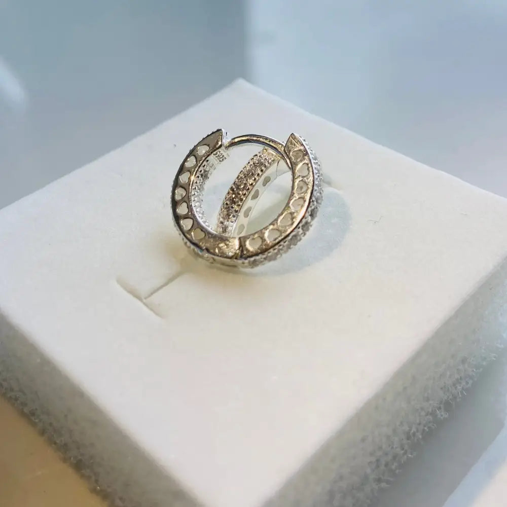 Silver flooded sleepers earrings with heart-shaped cutouts and pave-set gemstones